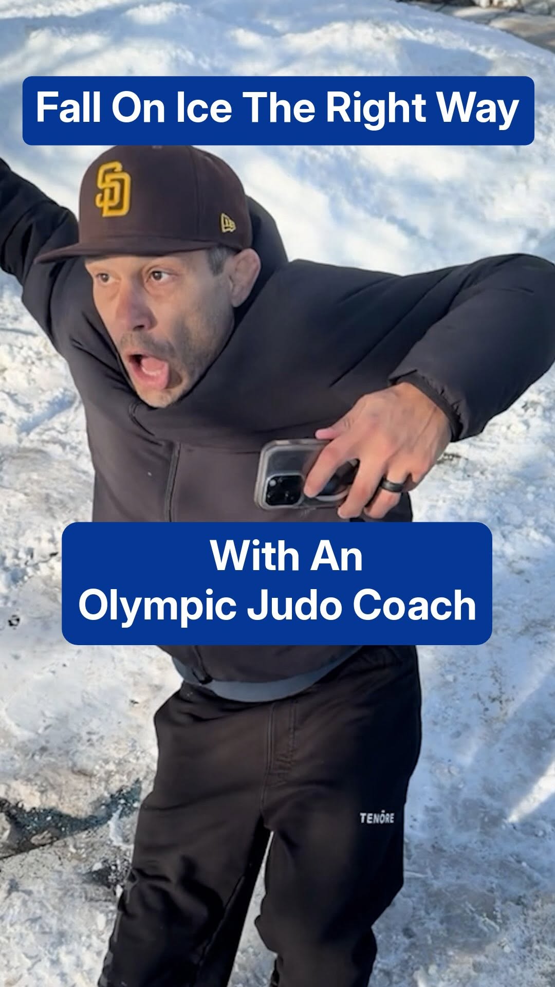 An Olympic judo coach demonstrating how to fall safely on winter ice